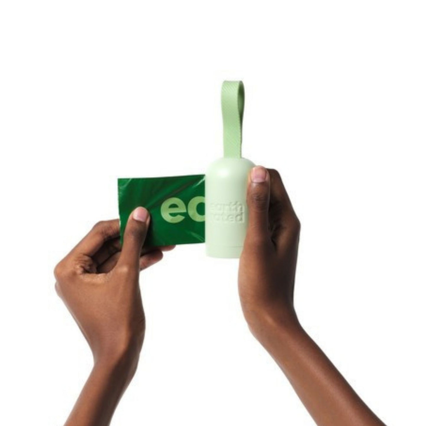 Hand holding a green eco-friendly product with packaging on a white background