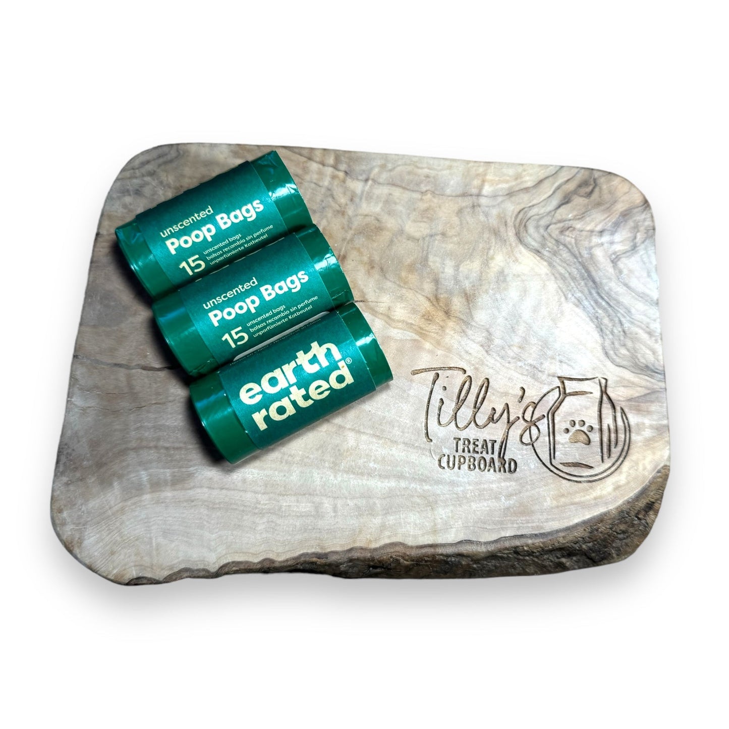 A roll of Earth Rated Poop Bags Unscented with 15 bags displayed on a wooden surface.
