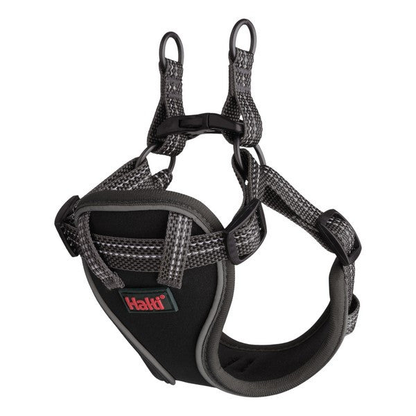 Black dog harness with patterned design on a white background