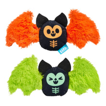 Two plush bat-shaped pet toys on a white background, one with bright orange wings and one with bright lime green wings. Both have black bodies with cartoon faces and orange/green skeleton details.