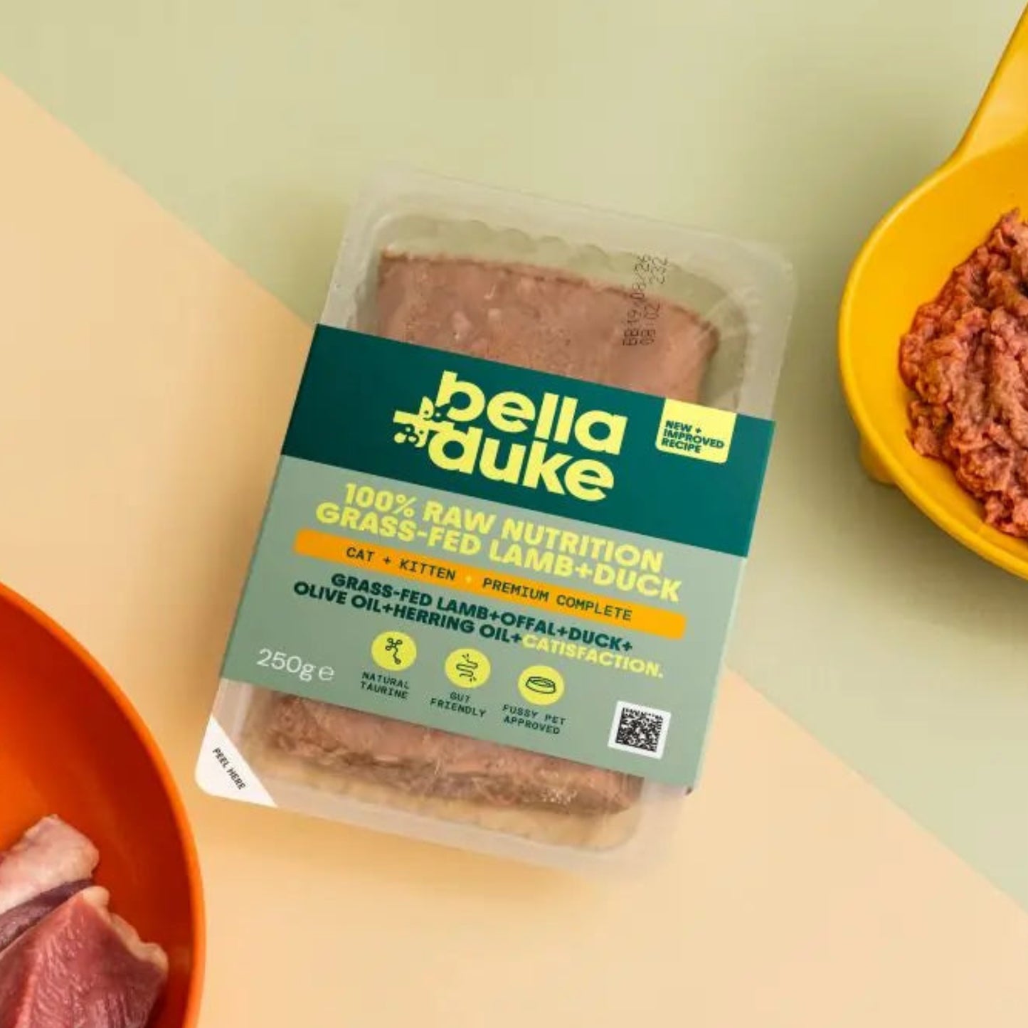 Bella Duke pet food packaging with raw meat on a yellow background