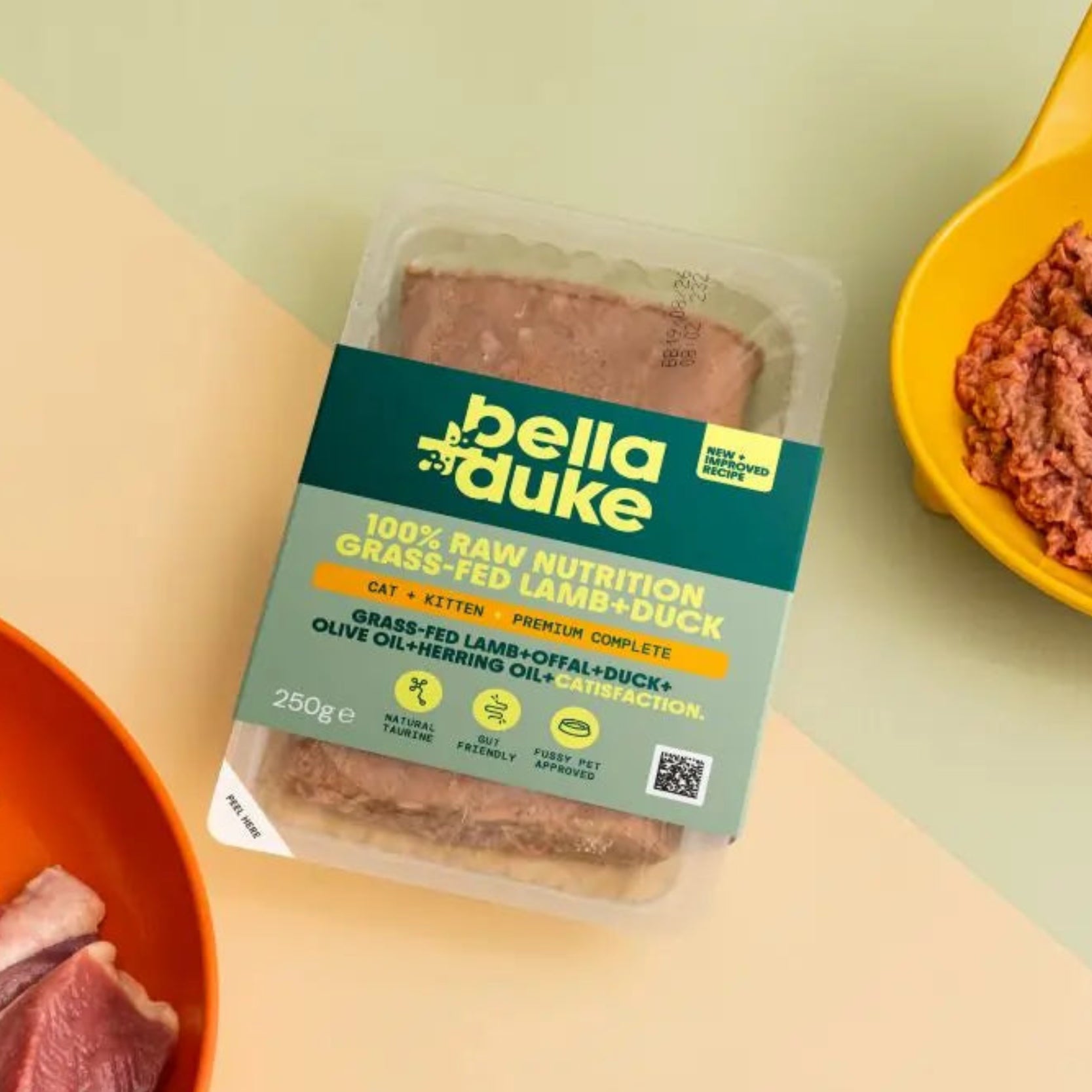 Bella Duke pet food packaging with raw meat on a yellow background