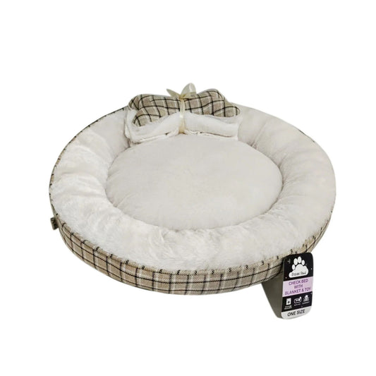 A round pet bed with a plush cream inner cushion and a beige plaid outer fabric, decorated with a matching blanket shaped like a plaid bow on top. A product tag is attached on the right side.