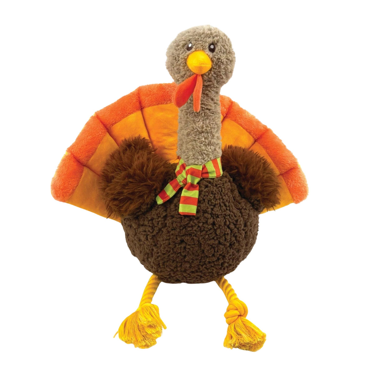 A plush turkey dog toy with a brown textured body, orange and yellow wings, a grey head, and a green and red striped bow, shown on a plain white background.