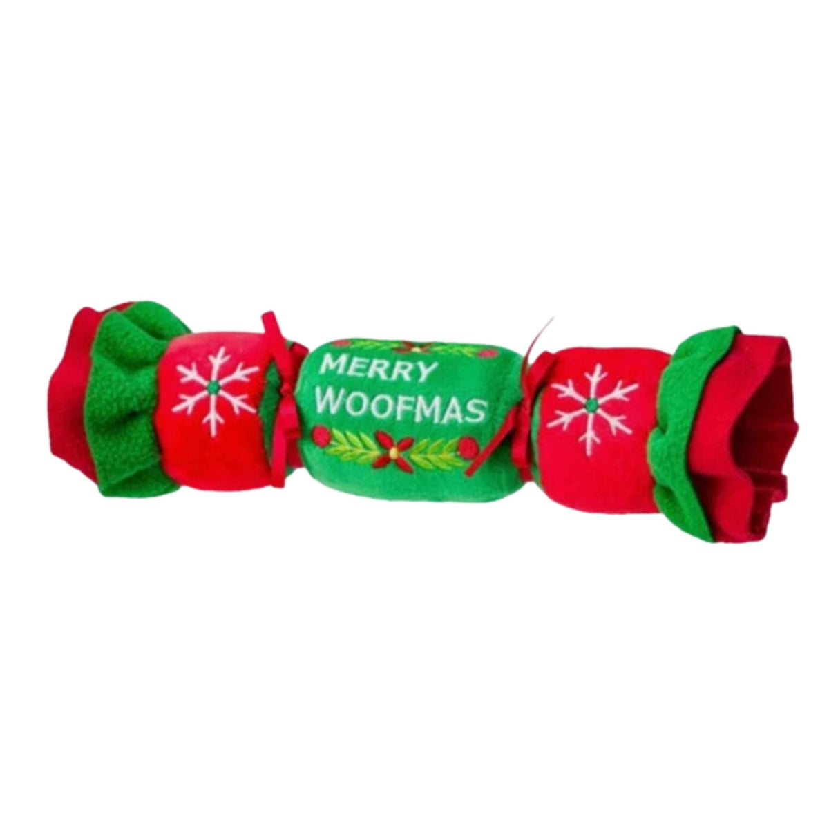 A festive Christmas dog toy cracker featuring red and green felt fabric with white embroidered snowflakes and the text 'MERRY WOOFMAS' on a green centre section.