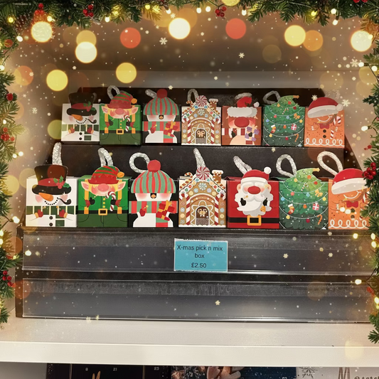 Set of Christmas-themed mini dog treat boxes on a shelf
