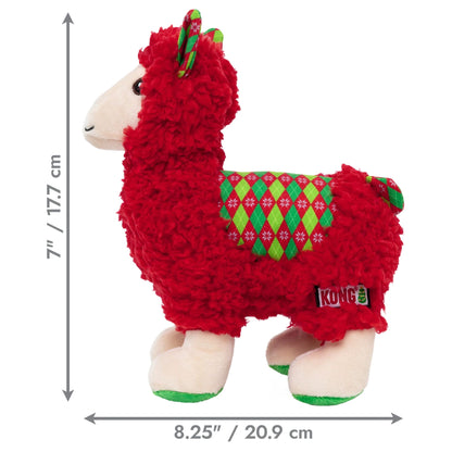 A red plush llama dog toy with cream-colored hooves and face, wearing a green and red argyle sweater, shown on a white background with dimension arrows indicating 7 inches in height and 8.25 inches in width.