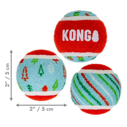 Three KONG dog toys shown on a white background with dimension arrows indicating 2 inches by 2 inches (5 cm by 5 cm). The toys are round felt tennis balls with red, light blue, green, and white holiday patterns, and the top ball has the KONG brand name printed in white.