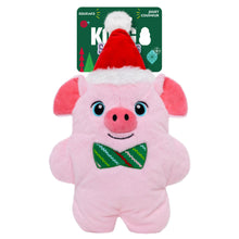 A pink plush pig dog toy with a red Santa hat and green bow tie, shown with its green retail tag behind it on a white background.