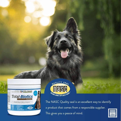 Dog sitting outdoors with a Total-Biotics supplement container and NASC quality seal label.