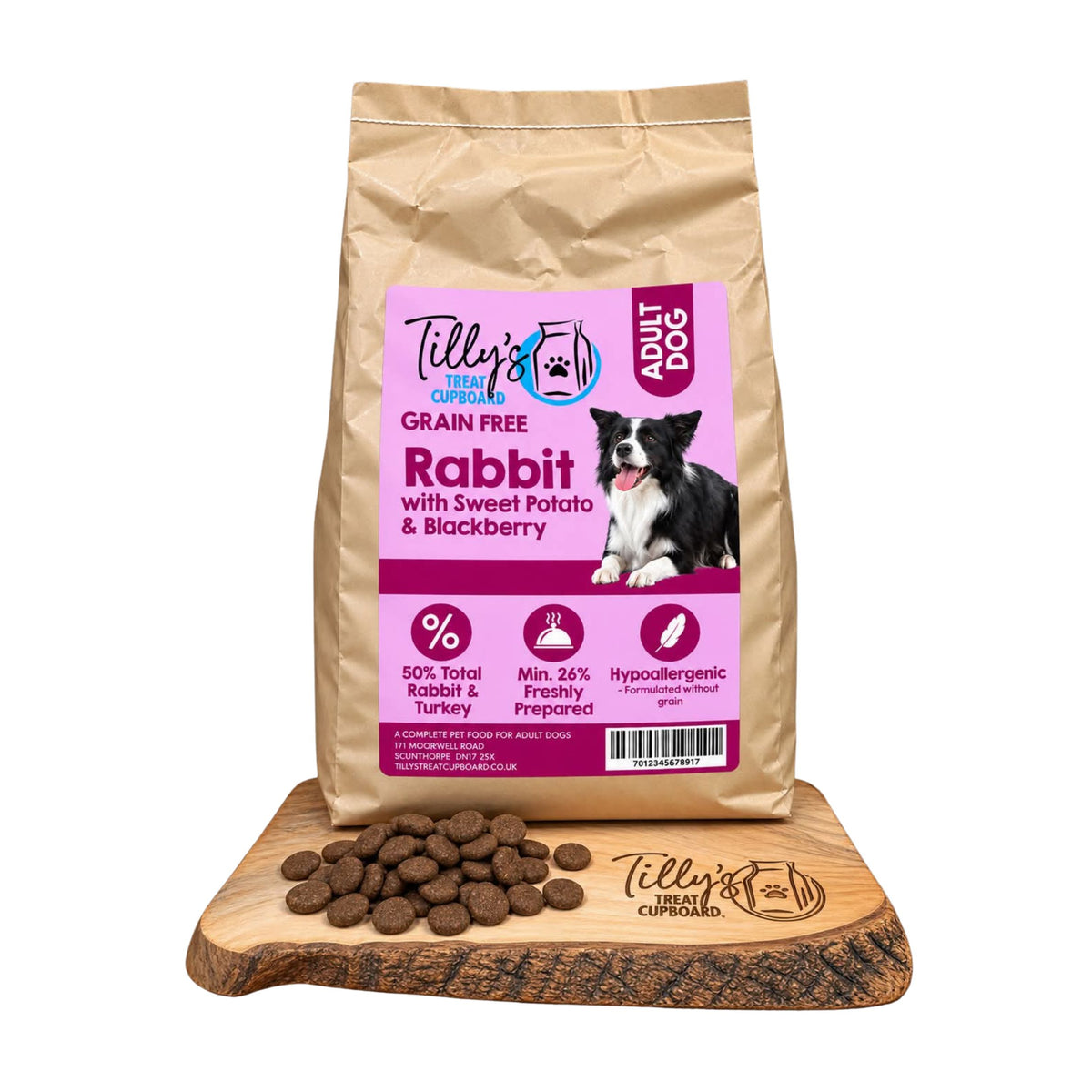A bag of Tilly's Treat Cupboard adult dog grain-free rabbit food with sweet potato and blackberry, displayed on a wooden slice with loose kibble pieces in front, against a plain white background.