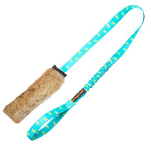 Dog toy with a blue handle and brown furry end on a white background