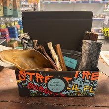 Dog treat box with dental chews and toys in a store setting