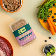 Packaged food with 'bella duke' branding on a table with vegetables and meat.
