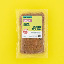 Packaged beef raw dog food from Bella & Duke on a yellow background