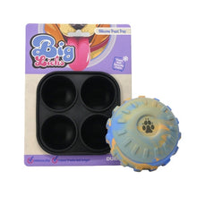 Treat filled ball with treat tray with packaging box featuring cartoon characters.