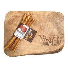 Chewllagen sticks labeled “Proper Beef” arranged on a wooden board, featuring the Tilly’s Treat Cupboard logo.