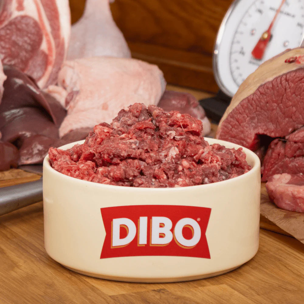 DIBO ground meat in a bowl with raw meat in the background