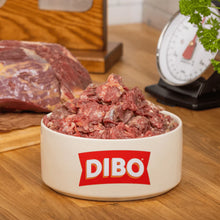 DIBO branded bowl with ground meat on a wooden surface