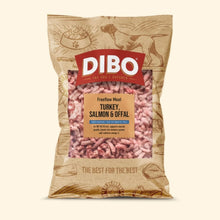 A bag of Dibo Freeflow Meat Turkey, Salmon & Offal dog food, shown on a solid light beige background. The packaging is a plaastice with brown illustrations of a dog and a bowl, featuring a prominent red Dibo logo and a clear window displaying the pinkish-red raw meat inside.