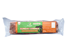 Packaged dog food with a label indicating 'Sunday Dinner' flavor on a white background