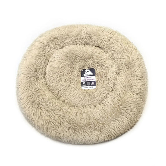 A round, plush faux fur pet bed in a light beige color, shown from a top-down view on a white background. A small black and white tag is visible in the center.