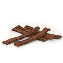 Several brown dried meat sticks or jerky strips arranged in a small pile on a plain white background.