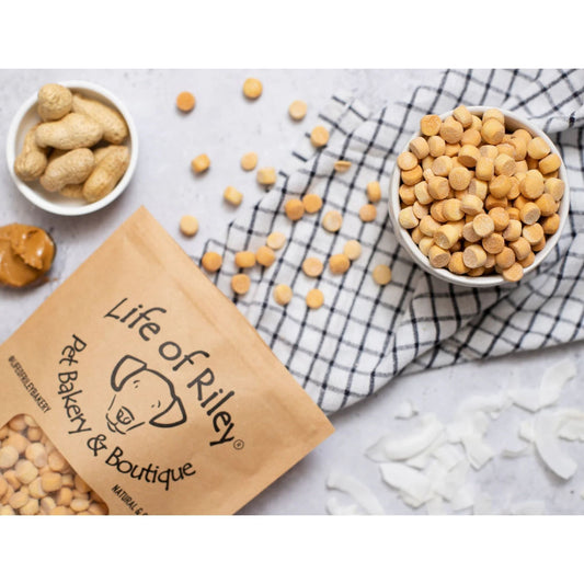 Life of Riley pet bakery products on a checkered cloth with scattered treats.