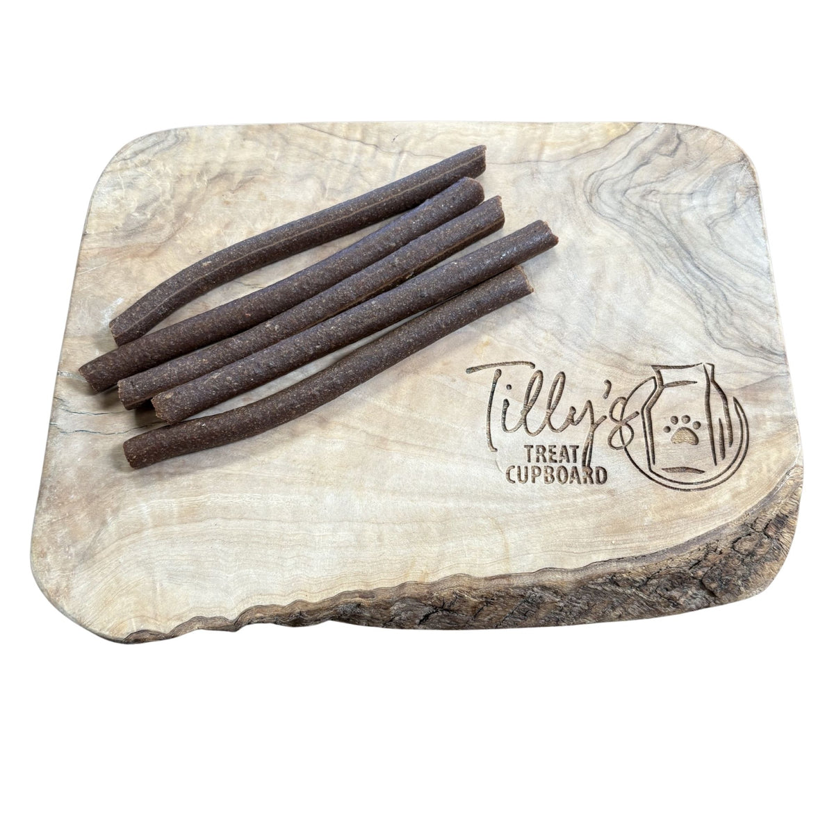 Wooden treat board with meaty dog treats and 'Tilly's Treat Cupboard' branding.