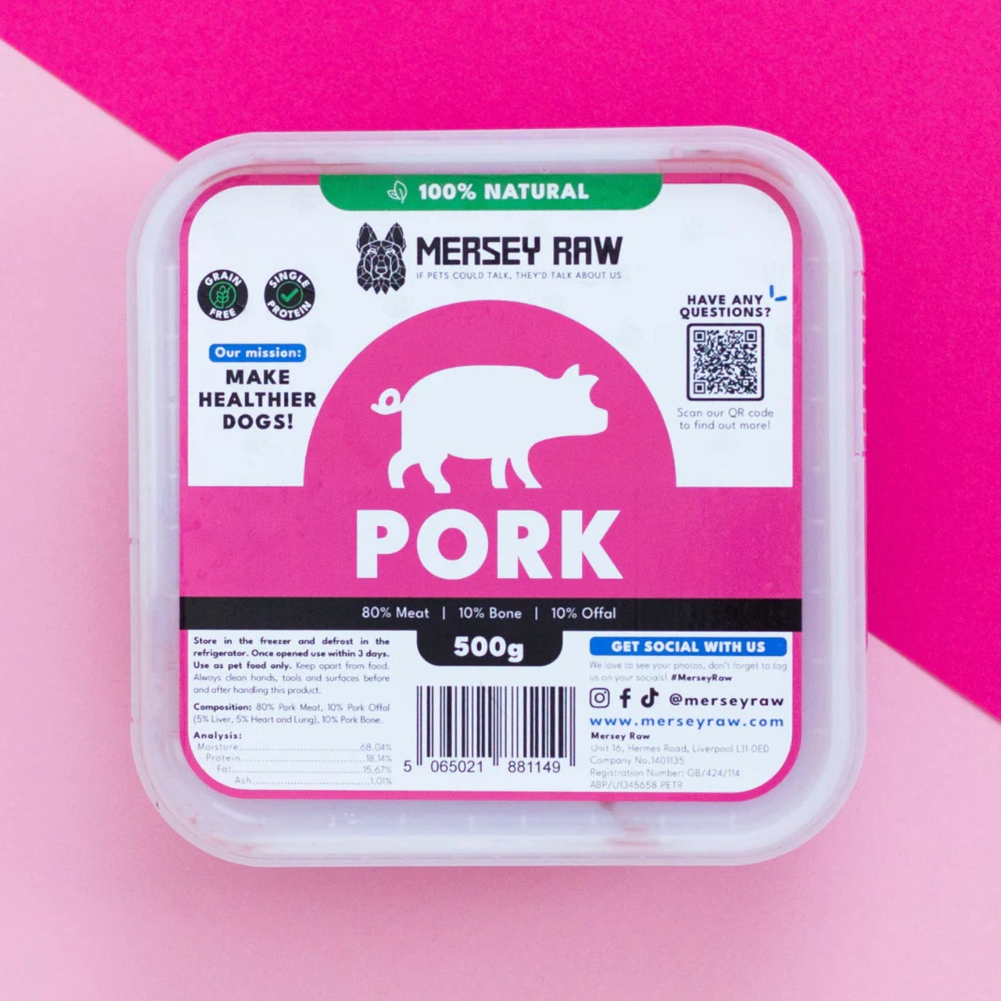 A 500g container of Mersey Raw Pork dog food, featuring a white and pink label with a pig silhouette, set against a pink and dark pink background.