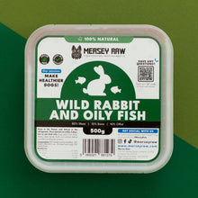 Mersey Raw dog food container with a clear plastic lid and a white label featuring green and black graphics. The label reads 'Wild Rabbit and Oily Fish' and '500g'.