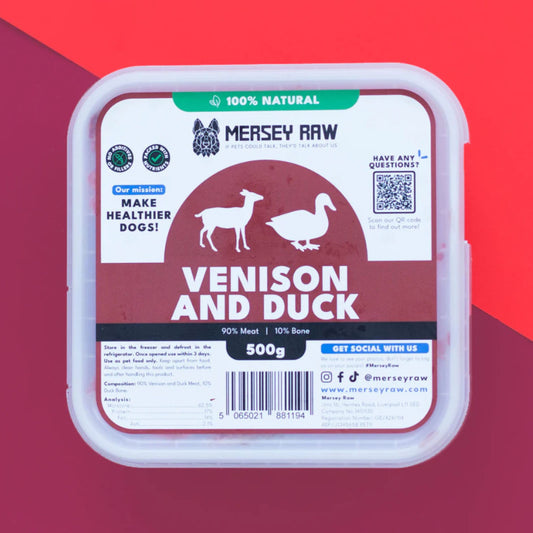 Mersey Raw Venison and Duck dog food in a clear plastic tub with a white lid, set against a red and magenta background.