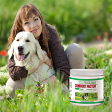 Woman with a dog in a grassy field next to a container of Comfort Factor supplement.