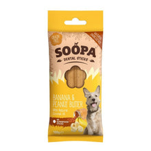 A package of Soopa Dental Sticks dog treats, Banana & Peanut Butter flavor, featuring a yellow and beige bag with a picture of a dog and a clear window showing the treats inside.
