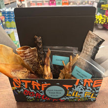 Box of pet treats with visible branding in a store setting