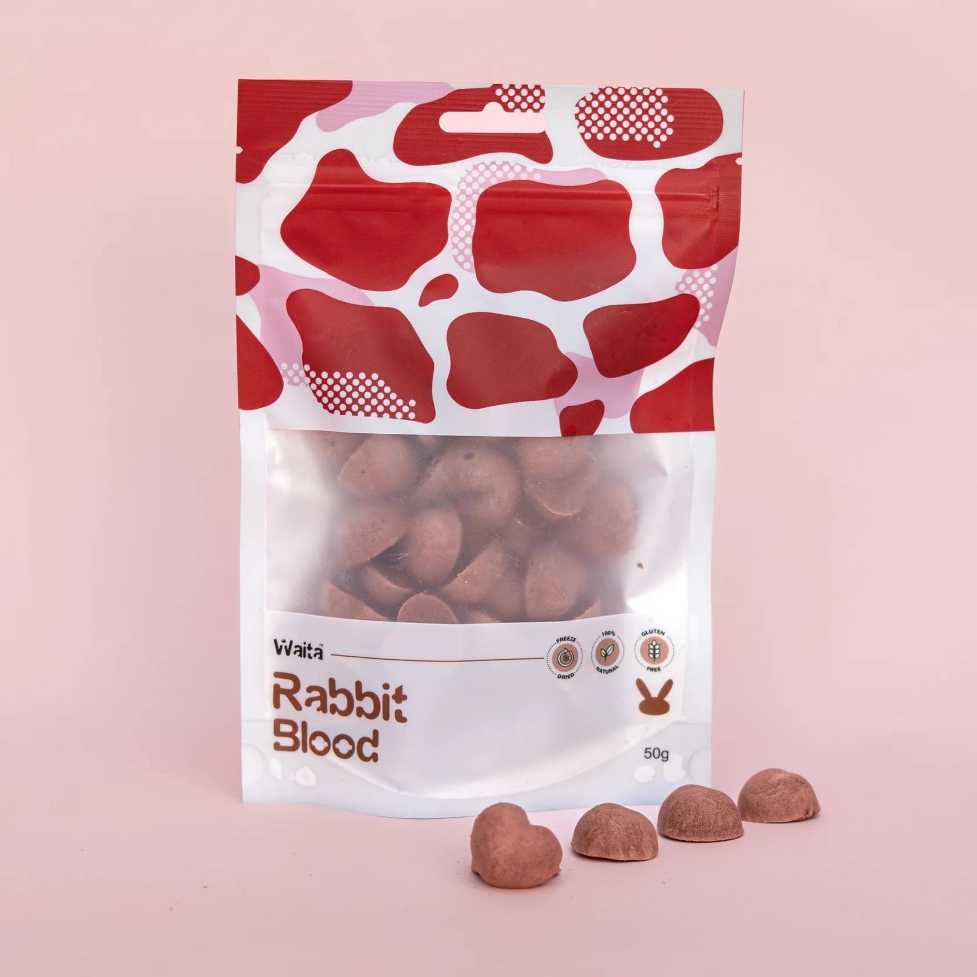 Package of rabbit blood treats with a red and white pattern on a pink background