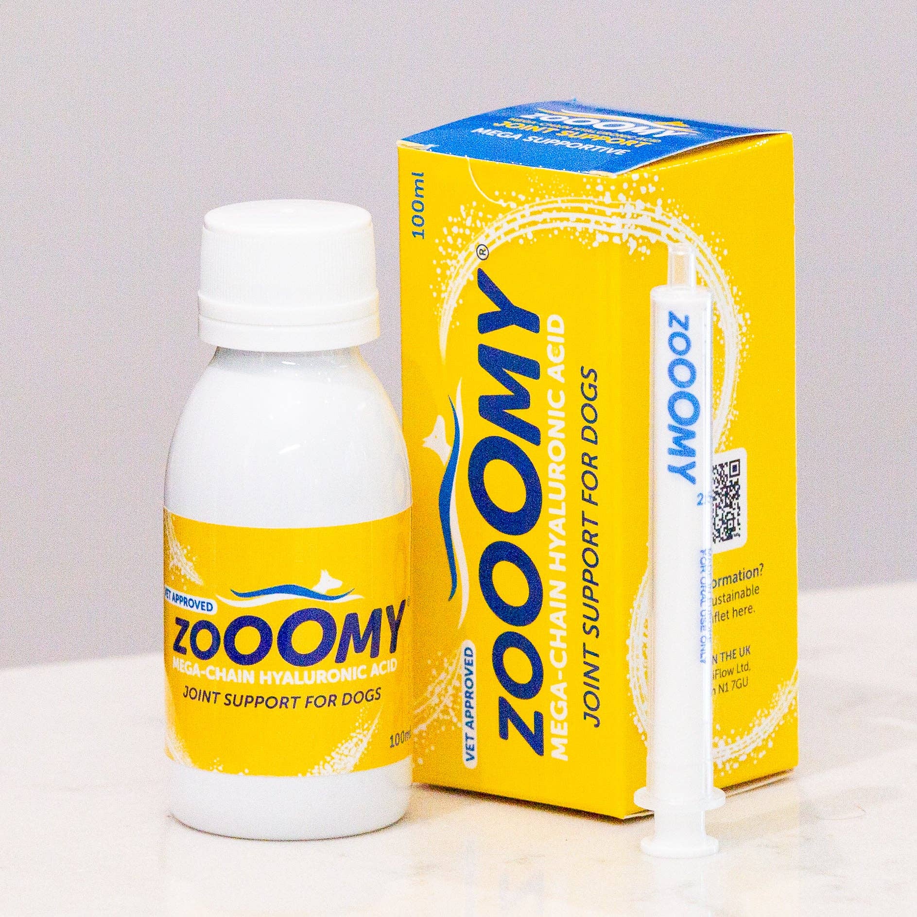 Zoomy bottle and box on a white surface with a light gray background